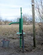 Hand pump leading to an artesian well. Pumping water for watering the garden