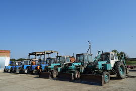 Tractor, standing in a row. Agricultural machinery. Parking of agricultural machinery.