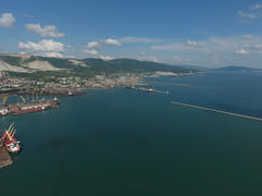 Top view of the bay Tsemess. The international sea port of Novorossiysk. Mol - building to stop the 