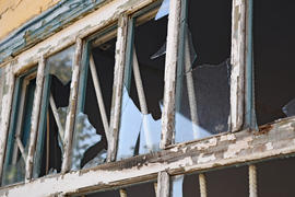 Windows with the broken glasses. The old thrown gas station