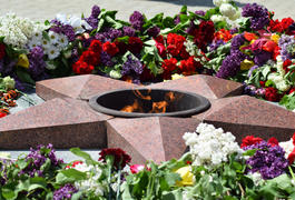 Eternal flame with flowers assigned to it. Celebration of May 9 Victory in the Great Patriotic War
