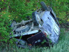 The car which moved down in a ditch as a result of accident. The turned car