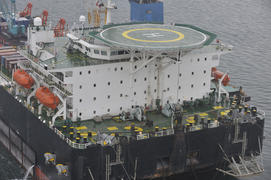 The cargo ship with the crane, the top view. Pipelaying barge