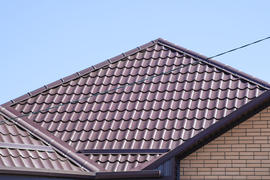 The roof of corrugated sheet. Roofing of metal profile wavy shape.