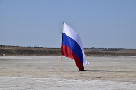 Russian flag on the bottom of a salty lake. Attributes country.