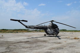 Old helicopter spraying fields. Helicopter spraying fertilizer.