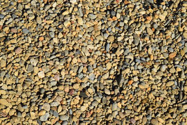 Background from small round crushed stone. A heap from a small pellet