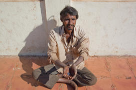 The beggar asks for alms in Old Goa near church