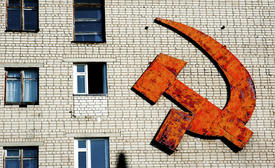 Hammer and sickle on the brick wall