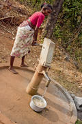 Woman collects water from the village column