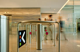 Employees pass through the turnstiles in the office center