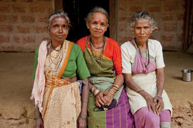 Three elderly women sitting on the bench in the Indian village