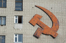 Emblem of the hammer and sickle on the wall of a house