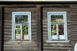 The windows of an old two-storey residential building in the city of Vishny Volochek