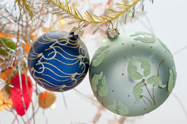 Two Christmas toys in the form of a ball hanging on a branch