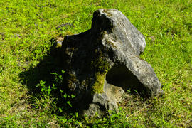 Big old stone on the grass in the park