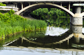 Bridge reflection through the river the Southern Bug