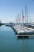 Boats and yachts stand at a quay in port