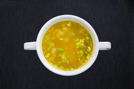  Tasty hot broth with meat and green onions. Horizontal view from above
